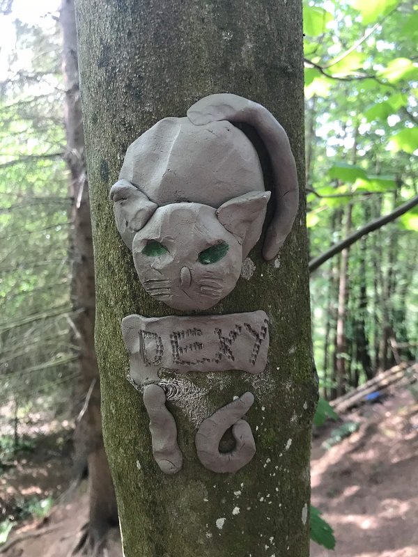 A creature made of clay stuck to a tree.